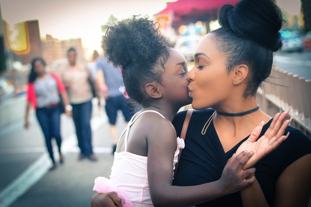 mom with daughter along the street